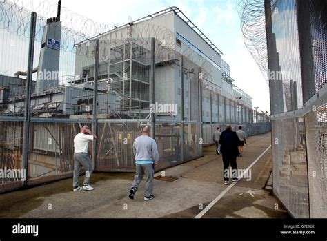 Inmates walk along the jetty to board Britain's only prison ship, HMP Weare in Portland, Dorset ...