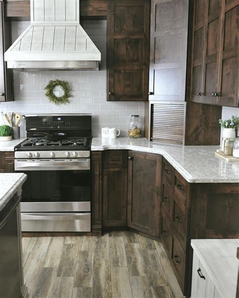 Dark alder custom cabinets with quartz countertops and gray subway tile ...