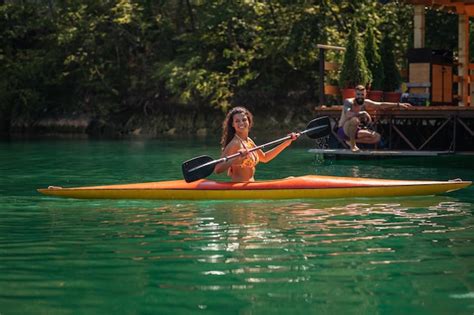 Premium Photo | Young woman canoeing in a lake on a summer day