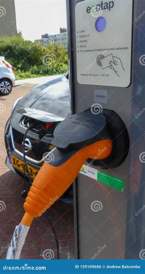 Nissan Electric Car Charging Batteries at Plug in Charge Station in the ...