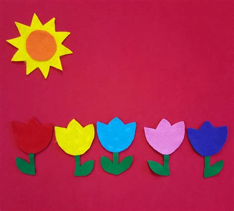 paper flowers and the sun on a red background