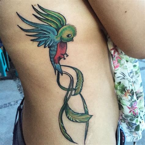 a woman's thigh with a tattoo design on her leg and a bird sitting on top of it