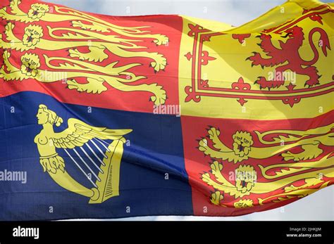 Heraldic flag. The Royal Standard of the United Kingdom blows in the ...