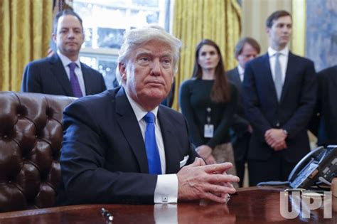 Photo: US President Donald Trump signs executive orders on oil ...