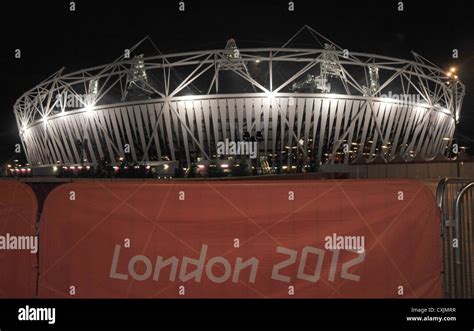 The Olympic Stadium with a 'London 2012' sign. Olympic Park at night ...