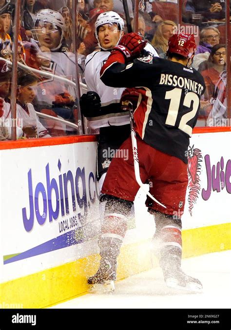 Phoenix Coyotes' Paul Bissonnette (12) checks Los Angeles Kings' Drew Doughty into the boards ...