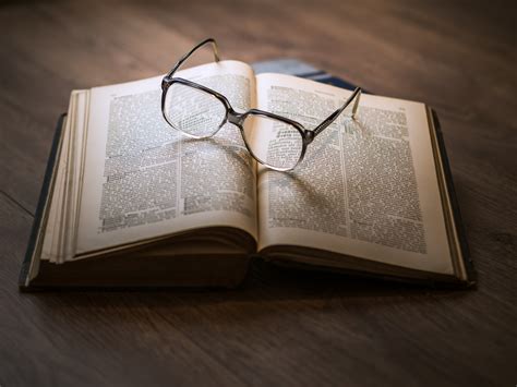Eyeglasses With Black Frames on Book · Free Stock Photo