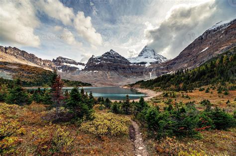 Mount Assiniboine with autumn forest at Lake Magog on provincial park ...