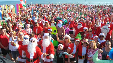 Live: Surfing Santas hit the waves for Florida's Christmas tradition