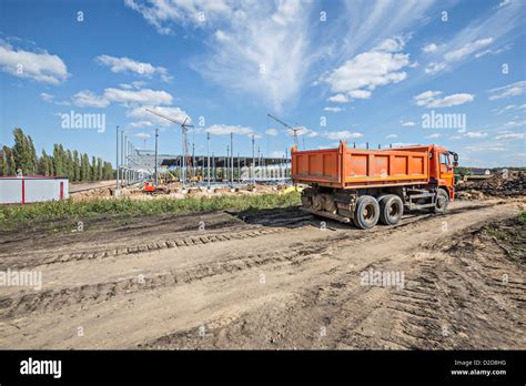 Dumper truck parked on dirt track at construction site Stock Photo - Alamy