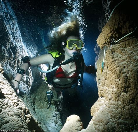 Deep and dark doesn't always mean cold: Jenny Pinder swims through the underwater passages of ...