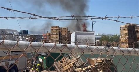 Pallet fire extinguished near light rail tracks in Denver - CBS Colorado