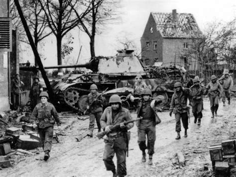 Panther Ausf. G from the 9th Panzer Division being bypassed by soldiers ...