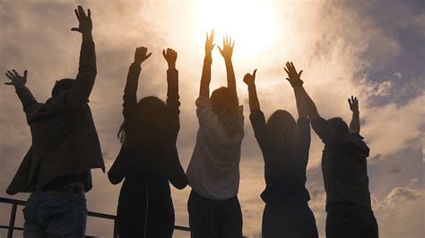 silhouette of people rejoicing and lifting up his hands. a group of successful businessmen happy ...