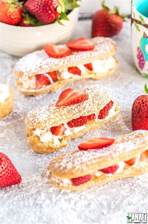 Homemade eclairs filled with whipped cream and fresh strawberries! These eclairs are lightly ...