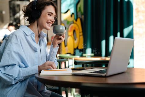 Happy Nice Girl Drinking Coffee while Working with Laptop Stock Image ...