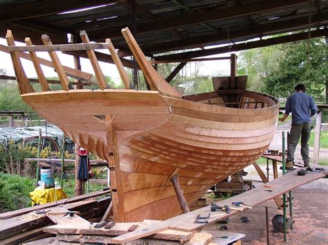 Caulking the oak planking on an English cutter. It appears to be partly planked carvel and ...