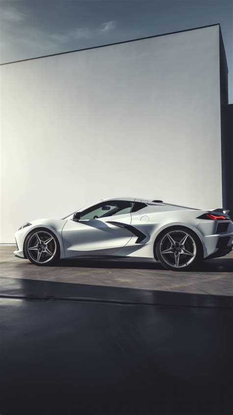 A 2023 Chevrolet Corvette Stingray in Arctic White, photographed from the side to showcase its ...