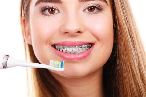 Woman Brushing Teeth with Braces Using Brush Stock Photo - Image of ...