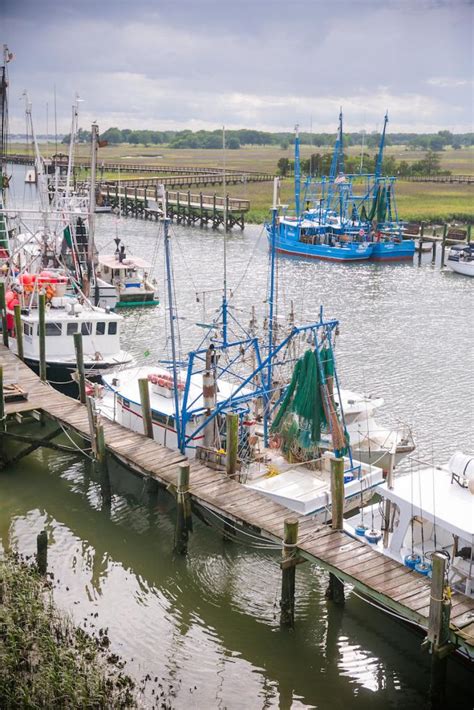 A boardwalk ceremony in Shem Creek Village shows how a waterside ...