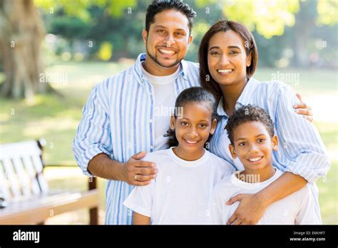 happy Indian family standing at the park Stock Photo - Alamy