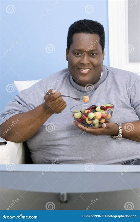 Obese Man Eating Fruits Royalty Free Stock Image - Image: 29651996