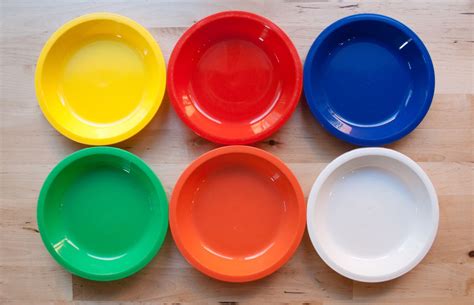 six different colored bowls sitting on top of a wooden table