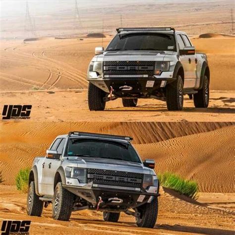 two trucks driving through the desert in different directions