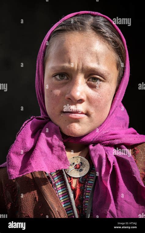 Afghanistan, Wakhan corridor, a portrait of a young girl with violet veil and blue eyes Stock ...