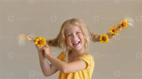 Laughing girl with yellow flowers in braids 5443407 Stock Photo at Vecteezy