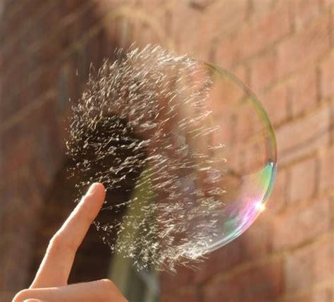 Slow motion picture sequence of bubble being popped | Geek Slop