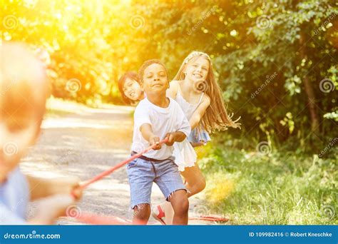 Group of Kids in Tug of War As a Team Stock Photo - Image of ...