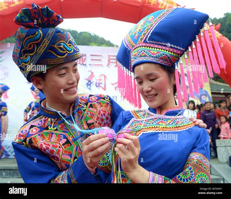 A couple of Chinese Zhuang ethnic group dressed in traditional costumes ...