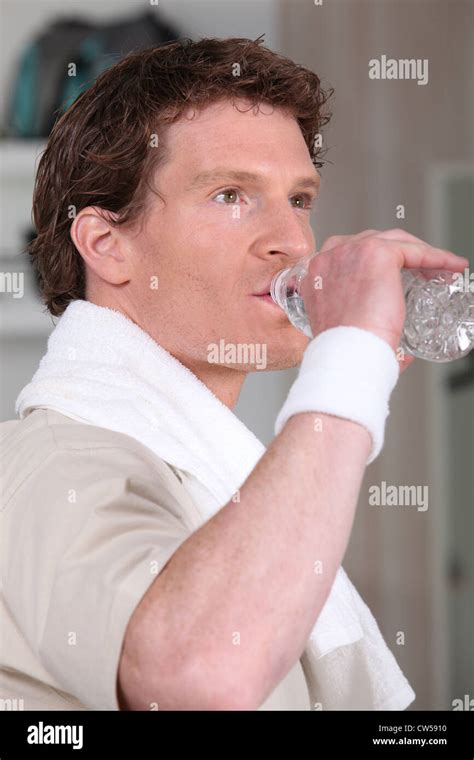 Man drinking water after gym session Stock Photo - Alamy