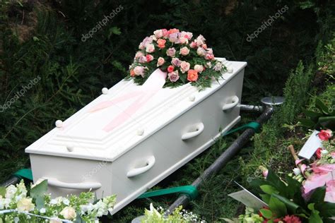 White coffin with pink sympathy flowers — Stock Photo © portosabbia #7546405