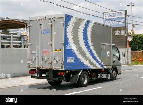 A Sagawa Express delivery truck drives past the Sagawa headquarters on July 28, 2017, Tokyo ...