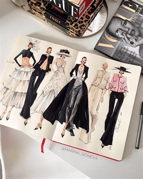 an open book with fashion illustrations on it next to a pen and scissors, some books