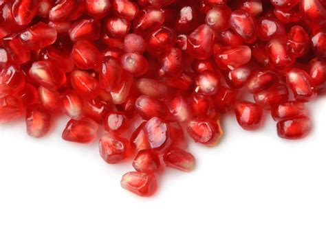 Premium Photo | Pomegranate seeds on white