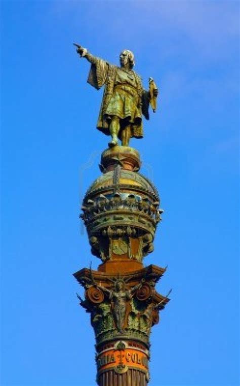 a statue on top of a building with a blue sky in the backround