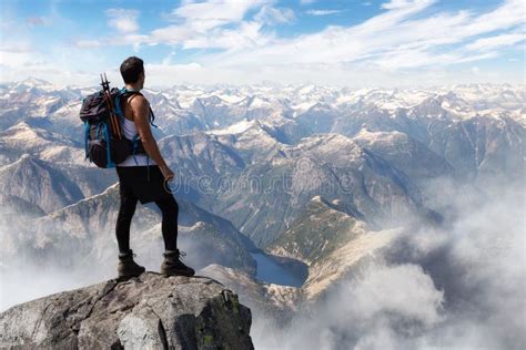 Adventurous Man Hiker on Top of a Steep Rocky Cliff Stock Photo - Image ...