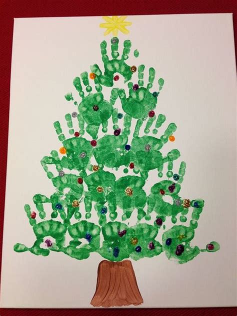 a christmas tree made out of handprints on white paper