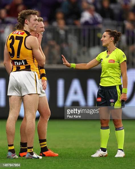 AFL Field Umpire, Eleni Tee talks with James Sicily of the Hawks ...