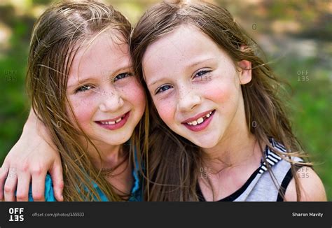 Portrait of two girls smiling together for the camera stock photo - OFFSET