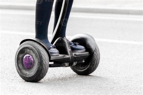 Female legs on electric scooter on a city street 2388751 Stock Photo at Vecteezy