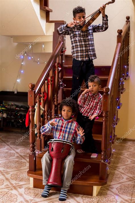 Afro children play three instruments. — Stock Photo © Denisfilm #103963138