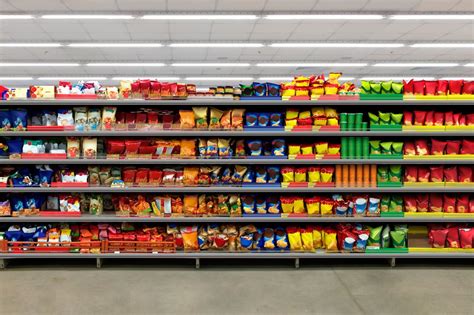 Chips and snacks on a shelf in a supermarket. Suitable for presenting new packaging among many ...