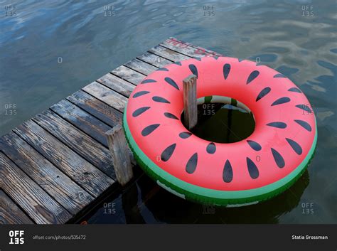 Elevated view of inner tube float and dock on lake stock photo - OFFSET