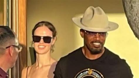 Jamie Foxx looks delighted as he holds hands with glamorous girlfriend ...