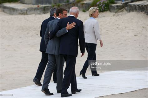 Emmanuel Macron, Frances president, left, walks arm in arm with U.S.... News Photo - Getty Images