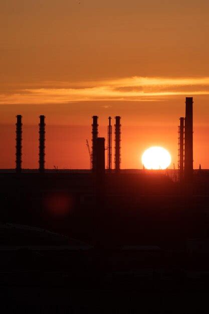 Premium Photo | Silhouette of factory at sunset